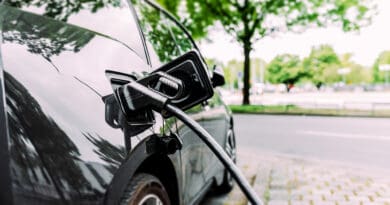 Charging modern electric car on the street.