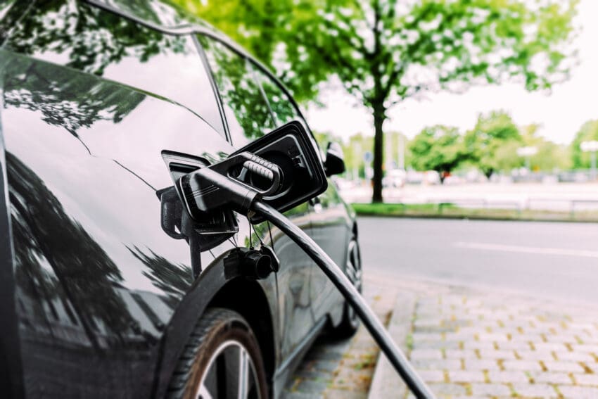 Charging modern electric car on the street.