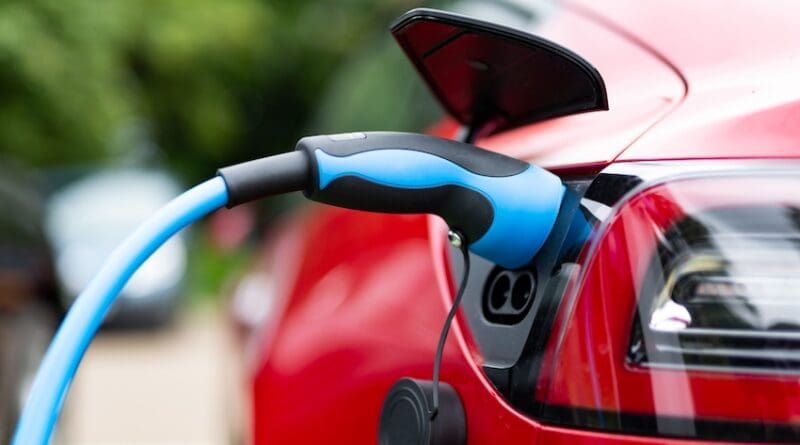 Electric car charging at plug in charge station