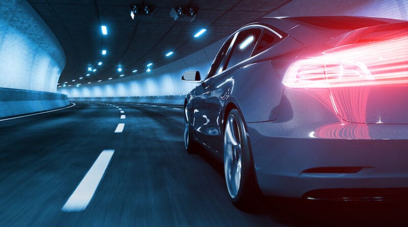 Modern Electric car rides through tunnel