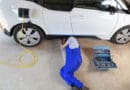 Mechanic repairing an electric driven car in garage