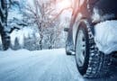 Car tires on winter road covered with snow