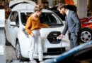 car-dealer-showing-customer-a-used-ev