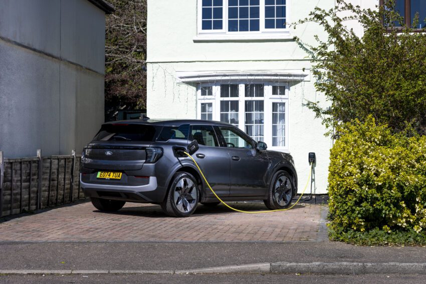 Ford Explorer electric car charging outside a house