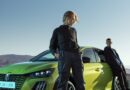two young men with peugeot e-208 to illustrate driver ignorance of evs