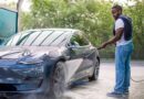 Driver washing an electric car