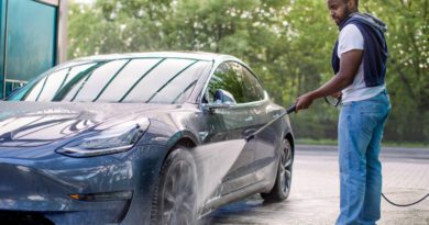 Driver washing an electric car
