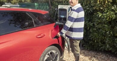 disabled driver charging an ev at public charger