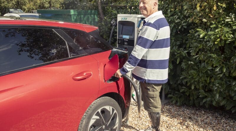 disabled driver charging an ev at public charger