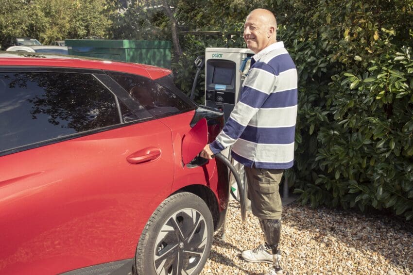 disabled driver charging an ev at public charger