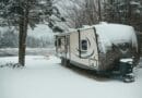 ravel trailer parked at snowy lakeside campsite
