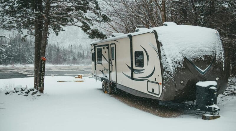 ravel trailer parked at snowy lakeside campsite